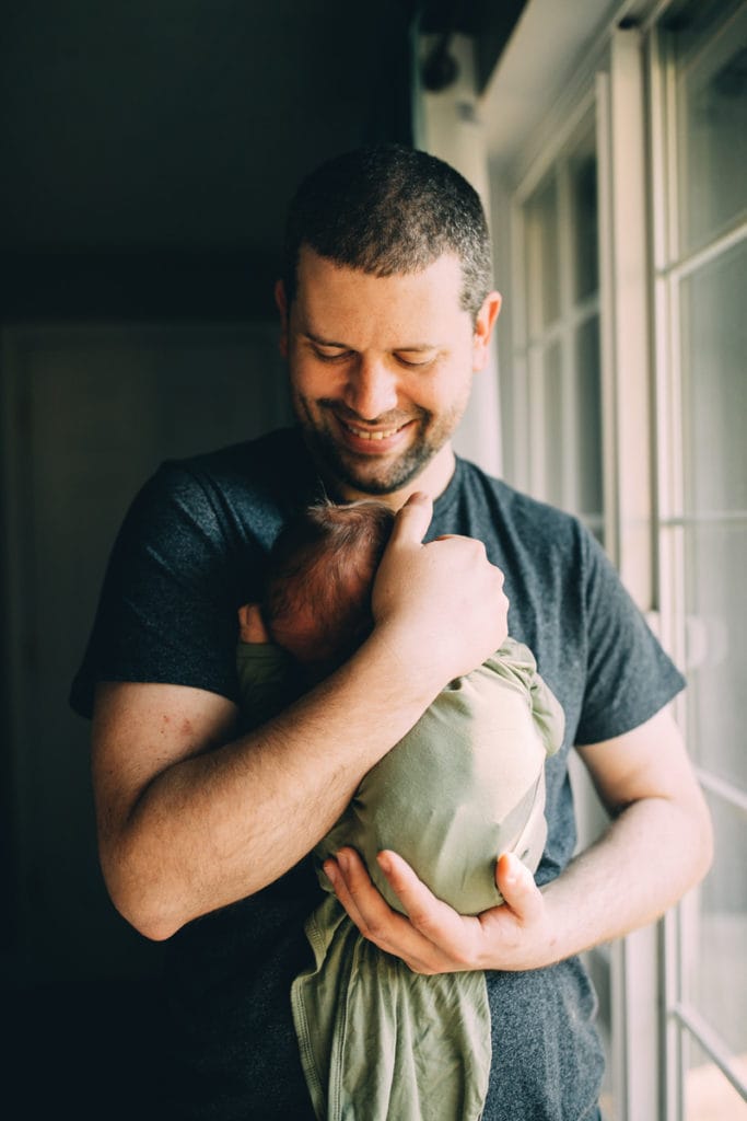 Fresh 48 Photographer, father holding baby to his chest