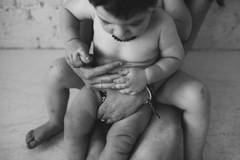 Motherhood Photography, a mother holds her little baby close at home