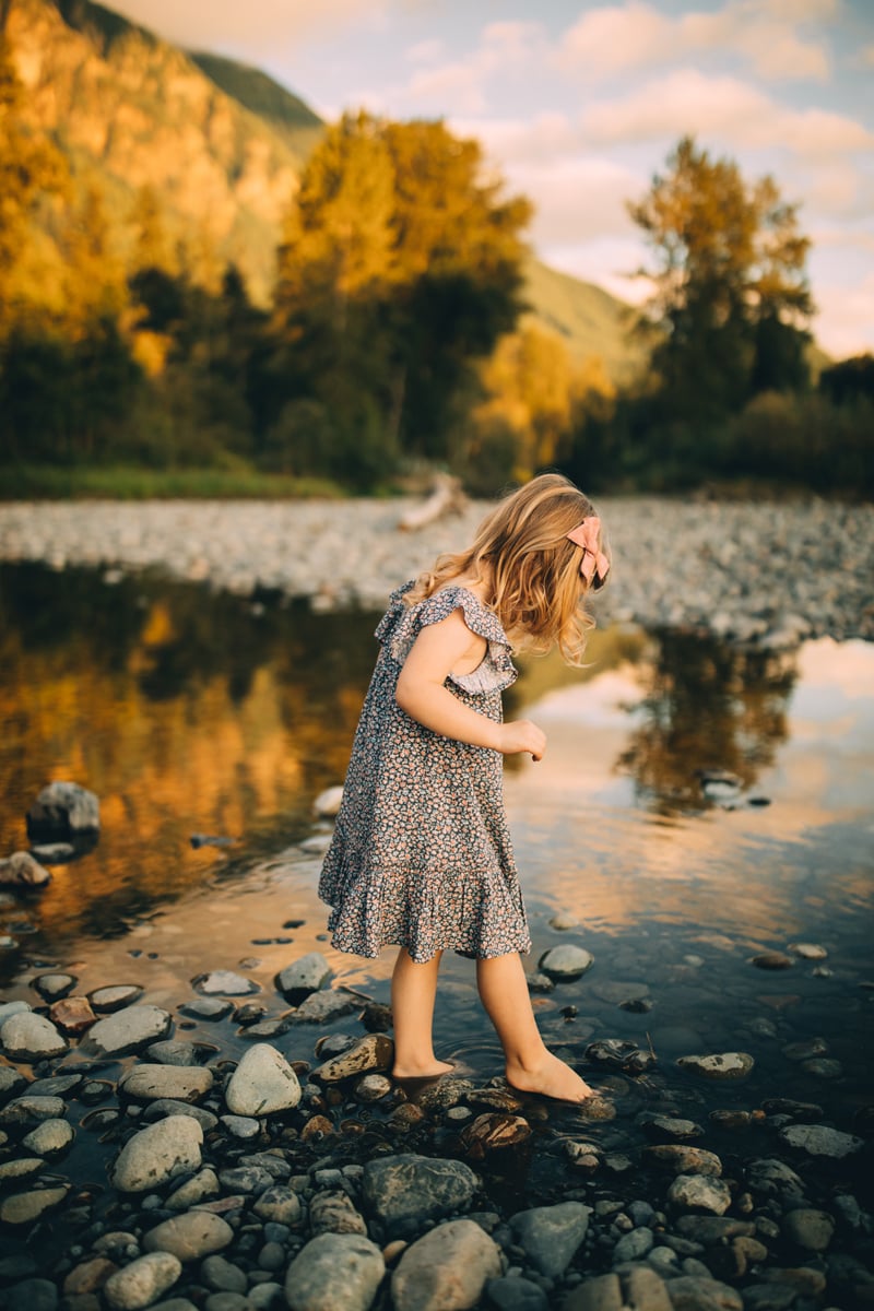 Family Photographer - Little girl steps into a quiet stream in the mountains