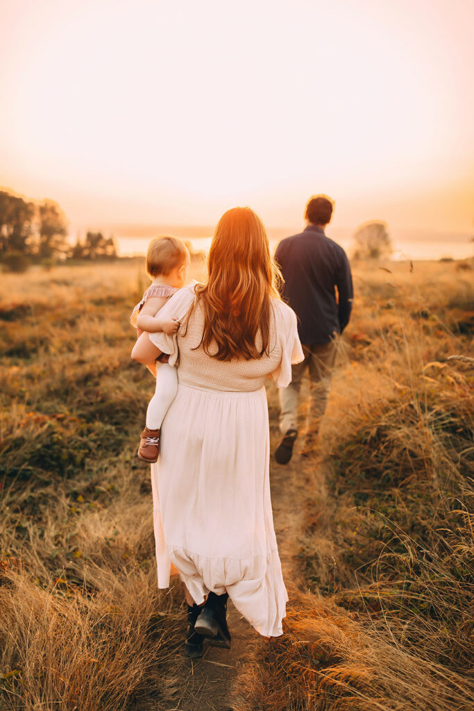 woman and man walking with child during photoshoot
