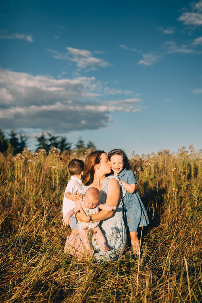 Mother and children posing in a field in Sequim WA for motherhood session/family photos