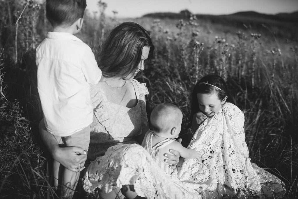 Mother and children posing in a field in Sequim WA for motherhood session/family photos
